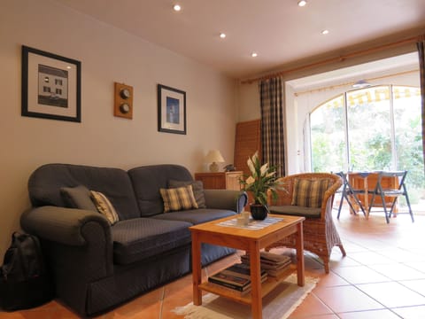 Living room opening onto sunroom and courtyard garden