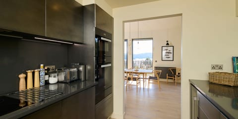 The kitchen leads directly into the dining area of the living room