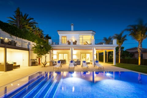 night view of villa and pool, lighting comes on automatically each evening.