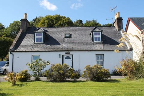 Grassy front garden leads onto the shore line.