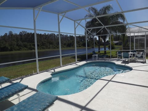 Newly resurfaced pool facing lake and conservation area