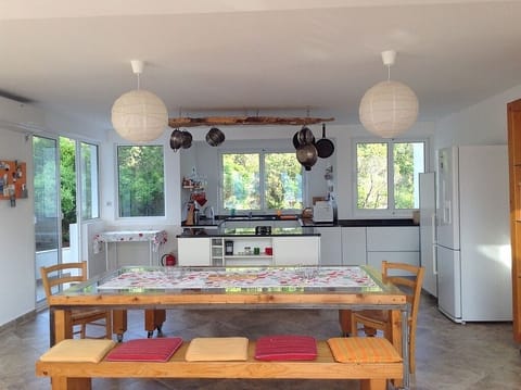 Dining table with kitchen in background