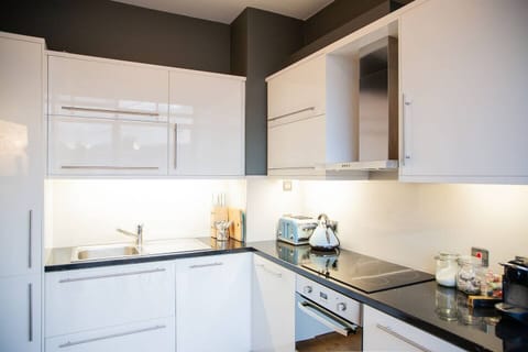 A separate, full kitchen with fridge, freezer, dishwasher, washing machine, clothes dryer, full hob and oven, coffee machine etc