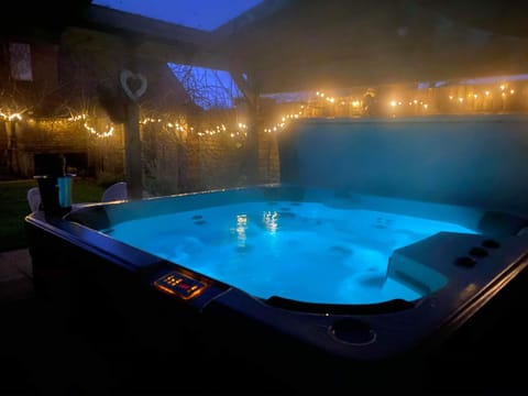 Outside enormous high quality hot tub , colour changing 