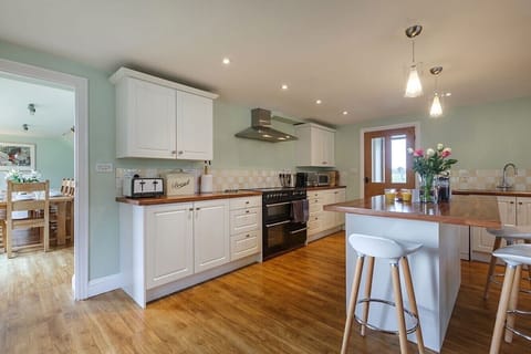 The kitchen features an electric range cooker, microwave and Nespresso machine