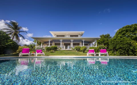 View of the villa and verandah from the pool at Sweet Breeze.
