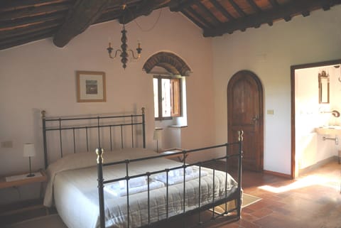 bedroom with ensuite bathroom and walk-in wardrobe