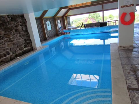 Private heated indoor swimming pool 12m x 7m accessed from lounge 1m to 2m depth