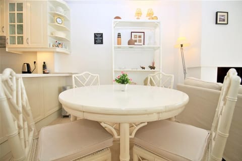 Dining area next to kitchen bar with seating for four guests
