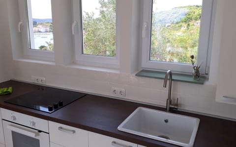 The minimalist white kitchen keeps the space uncluttered and functional