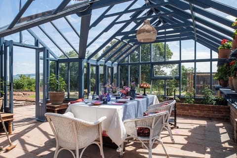 Glasshouse in the communal Wern-y-Wellness Garden