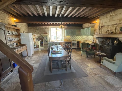 spacious kitchen dining room, massive beams, large table , woodburner