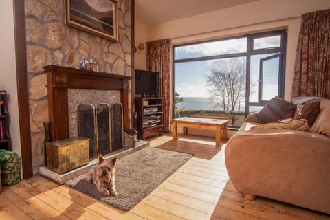 Sitting room with open fireplace and sea view