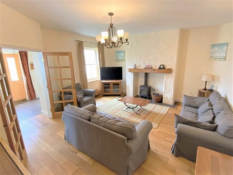 Spacious living area seats 6 adults. Log burner (safety guard under stairs)