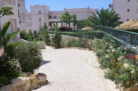 Grounds around pool, outside front door of apartment