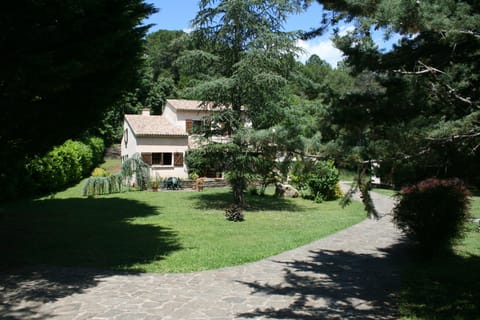 Front of property set in large private gardens and wildlife