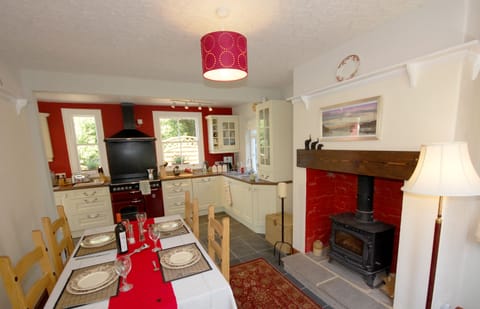 The dining room with wood burning stove and kitchen area.