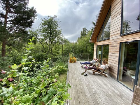 The private deck overlooking the River Nethy and forest