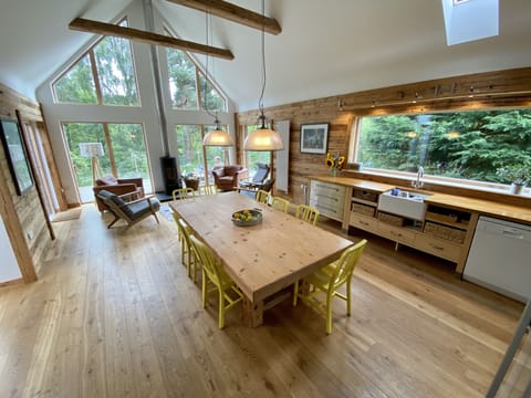 Open living, dining and kitchen area with wood burning stove