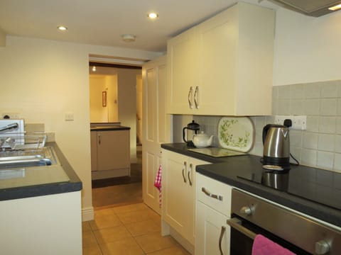 Well equipt kitchen with ceramic hob & dishwasher opens onto the breakfast room.