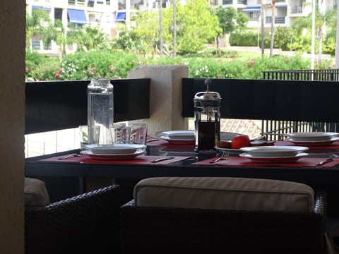 Balcony has awning to provide shade.