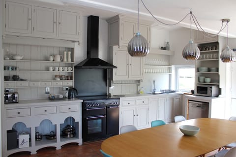 Spacious Kitchen showing large oak kitchen table that seats 10 people 