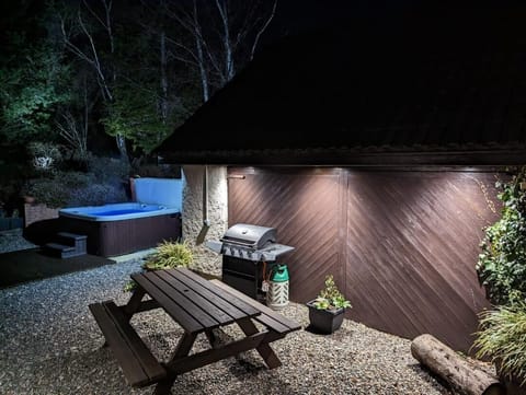Garage for bikes, picnic table and secluded hot tub area.