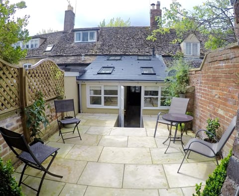 The sunny terrace with Indian sandstone patio and all weather garden furniture 