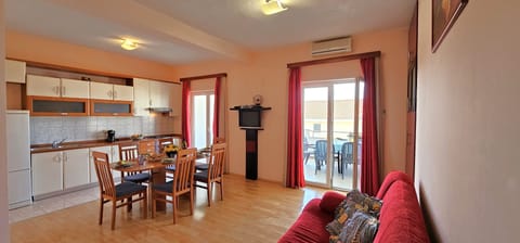 Open plan living/dining/kitchen area opening into sea view terrace