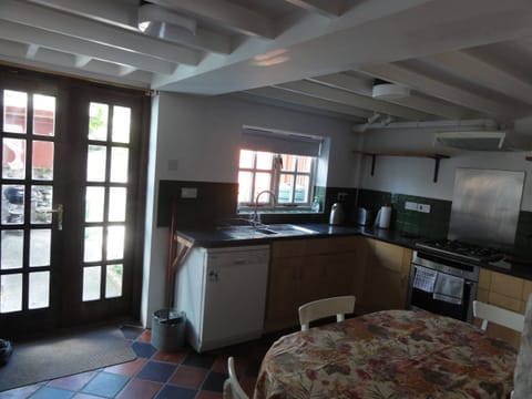 Newly refurbished kitchen, gas hob, patio doors leading to small patio area.