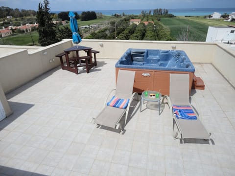 Private roof terrace with Hot tub, 4 sun loungers (2 shown), bench table, shower