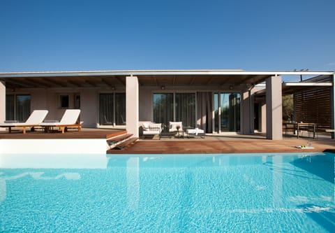 Relax on the hardwood sundeck next to the Pool
