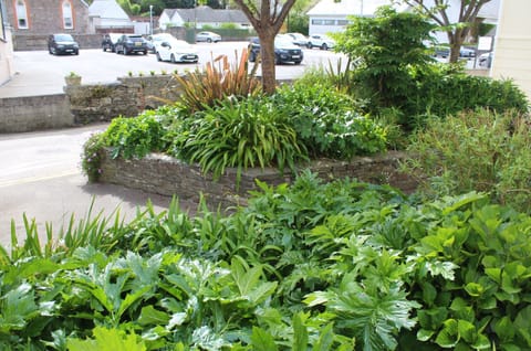 Public garden area opposite the Old Shop apartment with seating area.