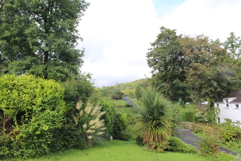 View of garden from lounge - the WHR steam trains are at the end of the path 