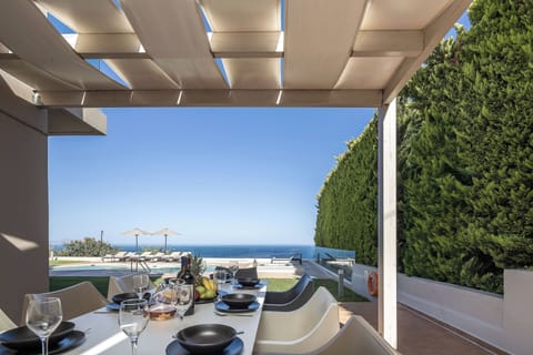 Dine al fresco with iconic sea views in shaded elegance.