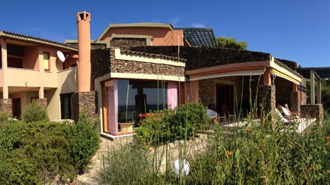 Front view with some details: main terrace and living room panoramic window
