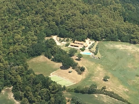 aerial view of house, pool and tennis court