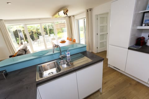 View from kitchen across dining table to garden