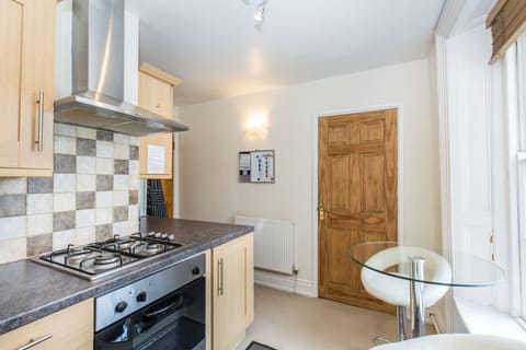 Door from kitchen into utility room with dryer