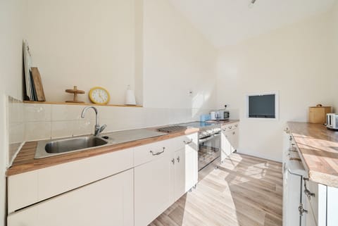 Kitchen with under counter dishwasher and freezer.
