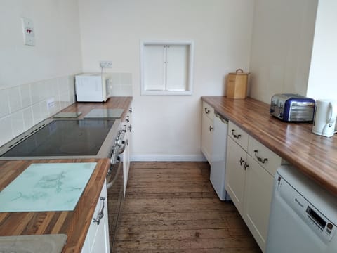 First floor kitchen with serving hatch to dining room