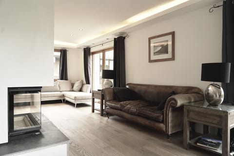 Open plan sitting room with oak floor, wood stove and underfloor heating