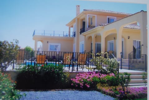 View of the villa and swimming area from the side garden