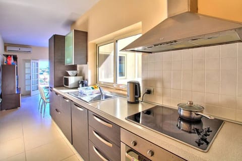 The galley style kitchen leading to the living-dining area