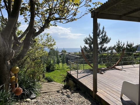 Deck, garden and sea.
