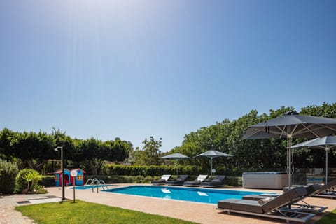 A 60 sqm salt water heated swimming pool with a safety pool alarm for children.