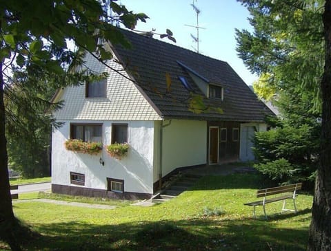 Vacation House with garden and bench.