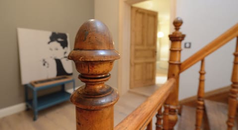 The ancient original staircase graces the hallway of the apartment.