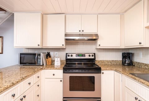 Kitchen View of microwave and stove/oven
