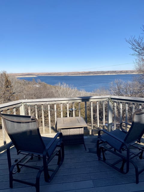 Full View of Lake from back deck with gliders, gas fire pit and grill